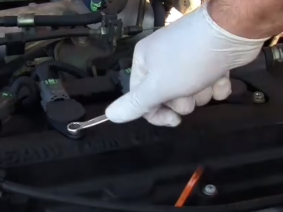 Откручиваем болт, закрепляющий катушку зажигания Nissan Primera